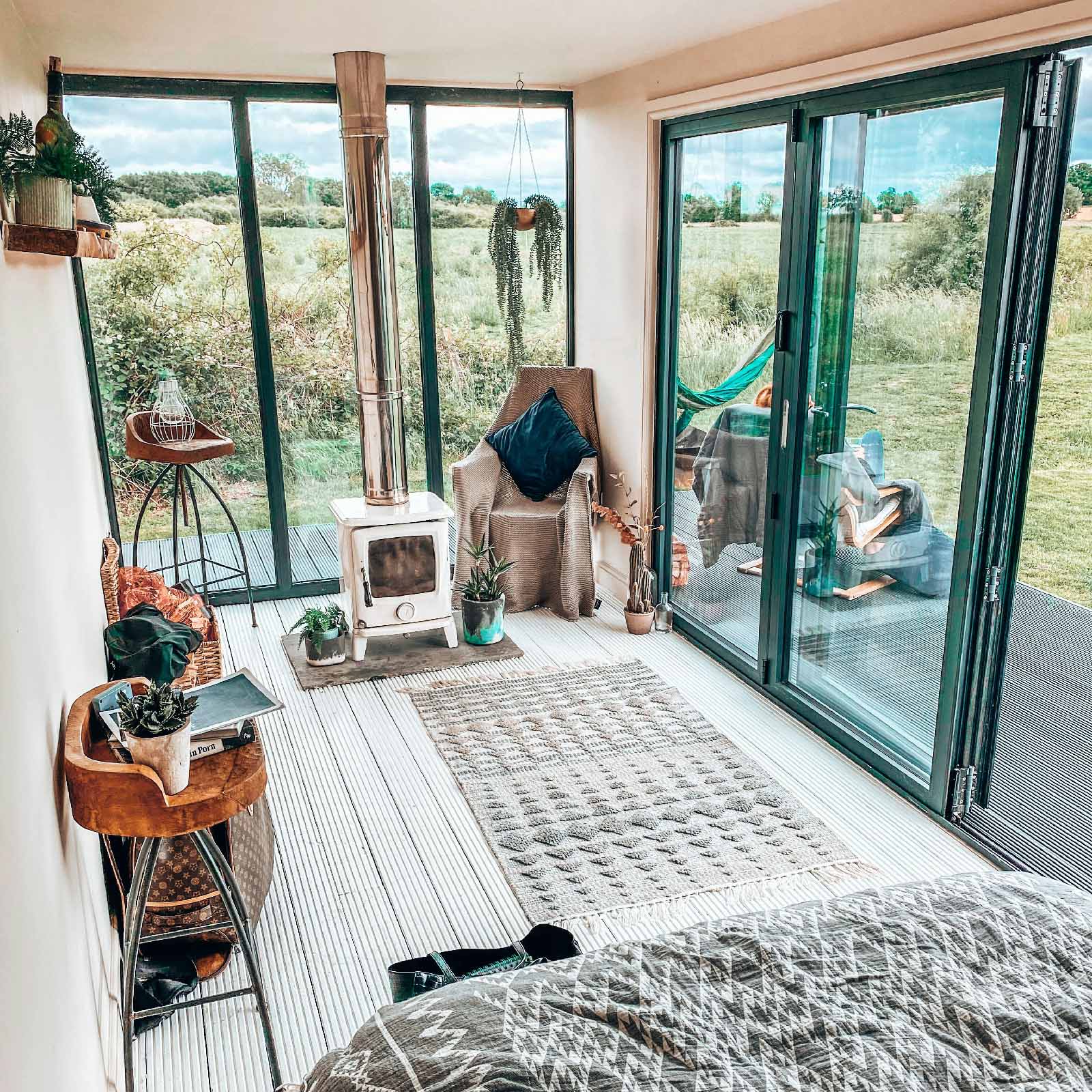 Tiny home interior with fireplace and tall windows