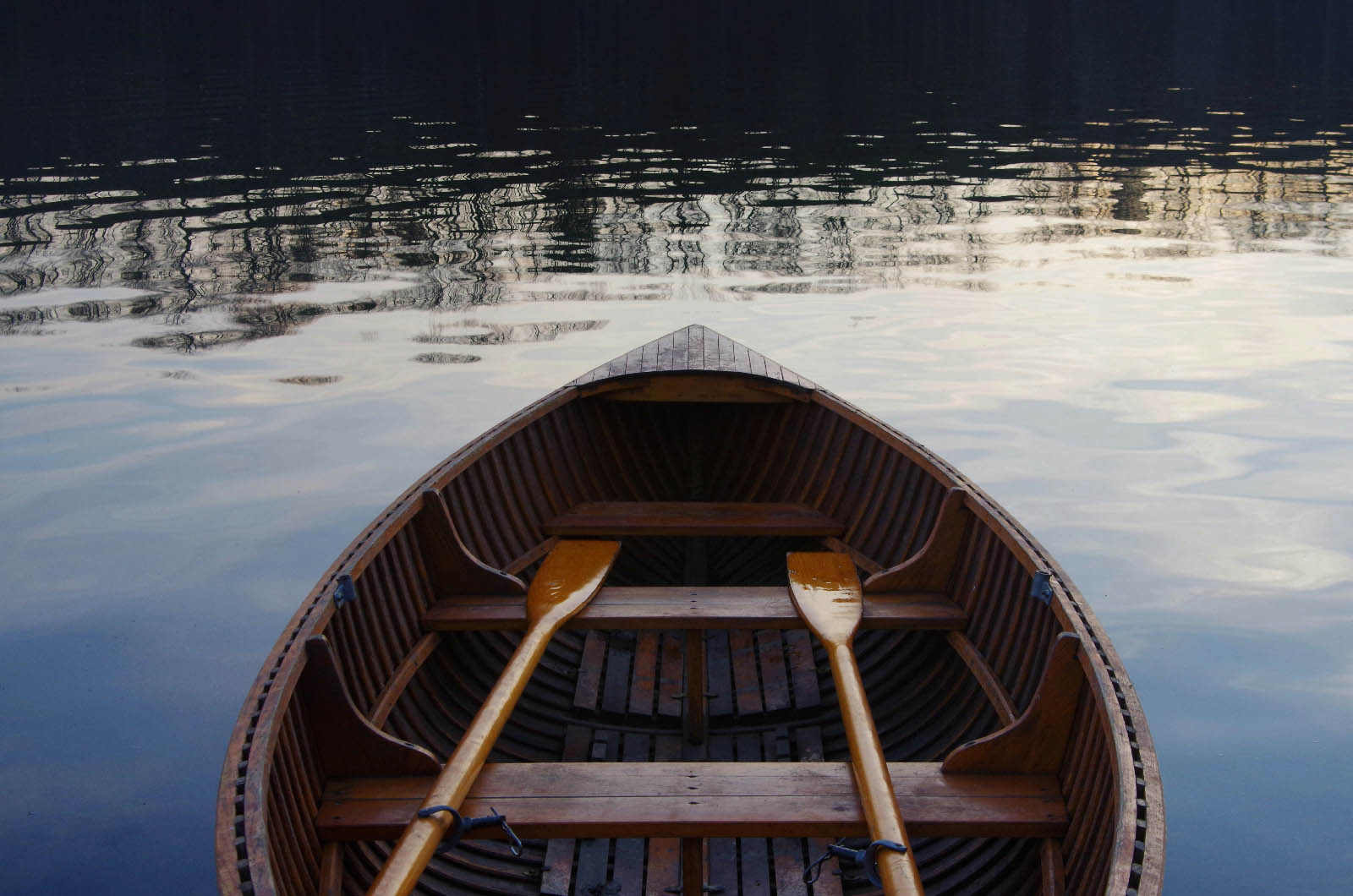 Wooden rowboat with oars